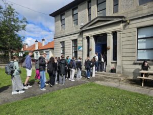 International Students in a queue entering an Irish Building