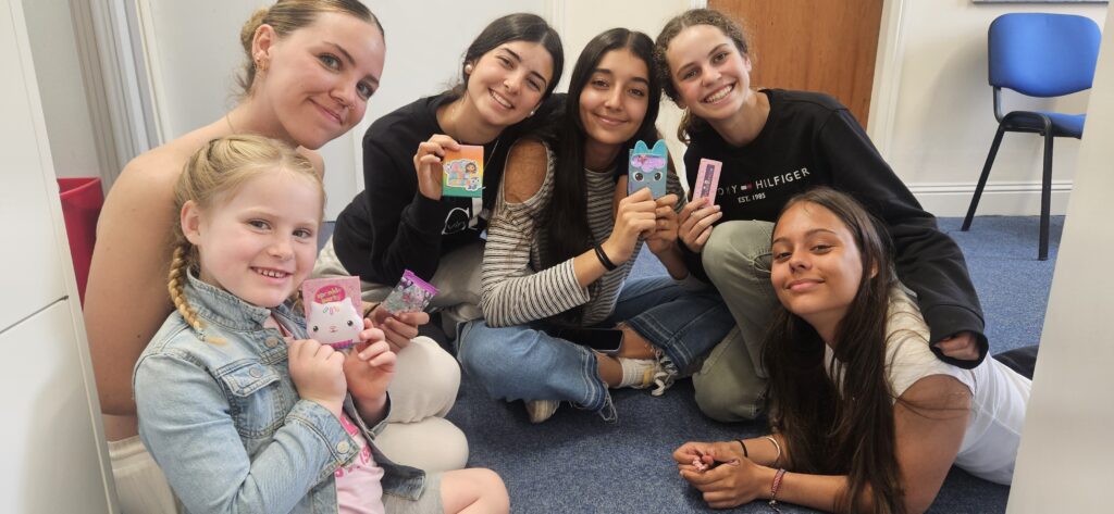 Group of teens and a girl together preparing for its English language class activity